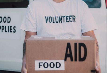 Volunteer Organizations - Volunteer Holding Box of Food Aid