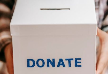Philanthropy - Crop anonymous person showing donation box