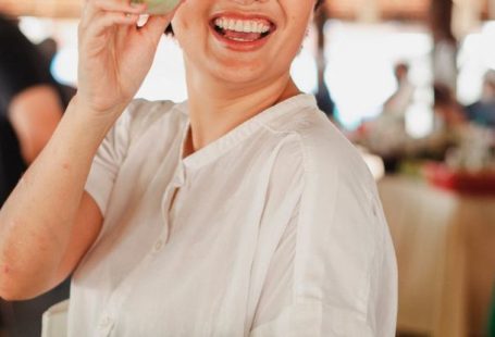 Local Nonprofits - Happy ethnic woman with salad leaf