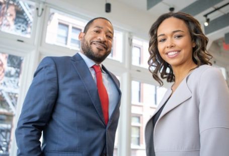 Corporate Partnerships - Man and Woman Smiling Inside Building