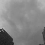 Financial Mistakes - Black and white photo of tall buildings with cloudy sky