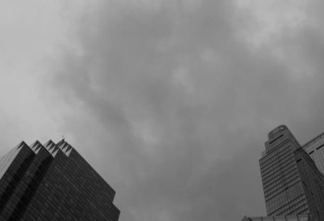 Financial Mistakes - Black and white photo of tall buildings with cloudy sky