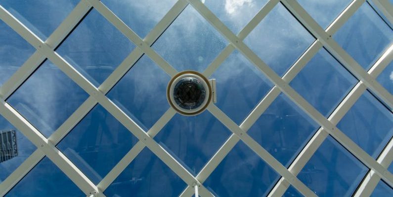 Innovators - A close up view of a glass roof with a camera